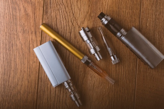 vape pen, mod, e cigarette, e-cig, on a wooden background.